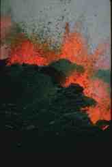 View of curtains of fire, main vents, and rampart built by spatter at 2,800 m elevation on Mauna Loa, March 26, 1984. This discontinuous row of lava fountains 15-30 m high occurs along a rift. The eruption which began on March 25 fed several lava flows, one of which threatened the City of Hilo. However, the activity stopped in early April and the flows stopped about 6.4 km short of the outskirts of the city. View of curtains of fire, main vents, and rampart built by spatter at 2,800 m elevation on Mauna Loa, March 26, 1984. This discontinuous row of lava fountains 15-30 m high occurs along a rift. The eruption which began on March 25 fed several lava flows, one of which threatened the City of Hilo. However, the activity stopped in early April and the flows stopped about 6.4 km short of the outskirts of the city.